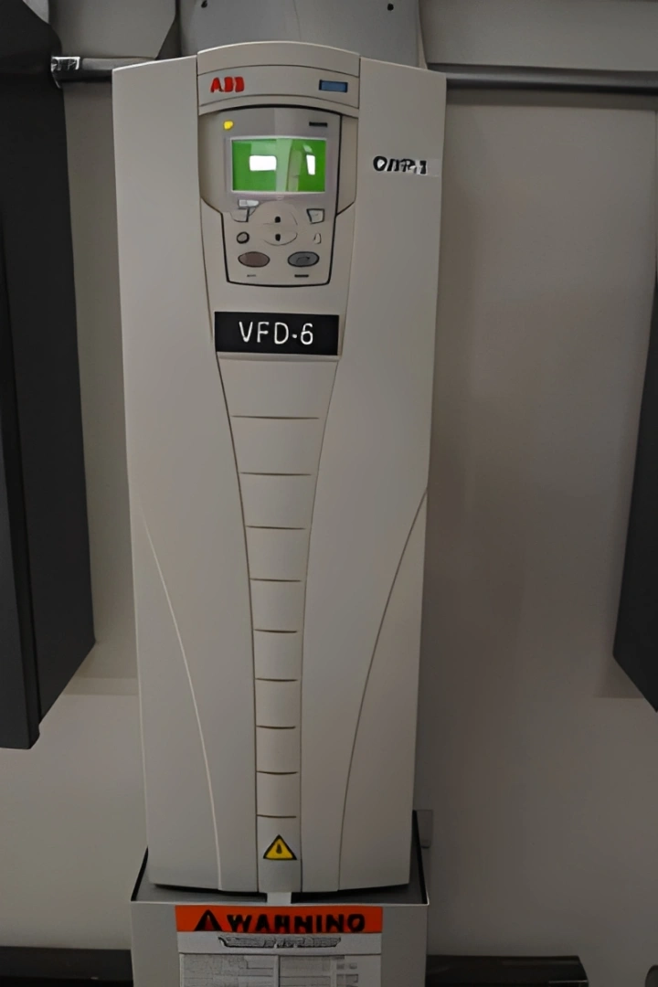 White and black electronic device, an ABB VFD-6, sitting atop a table