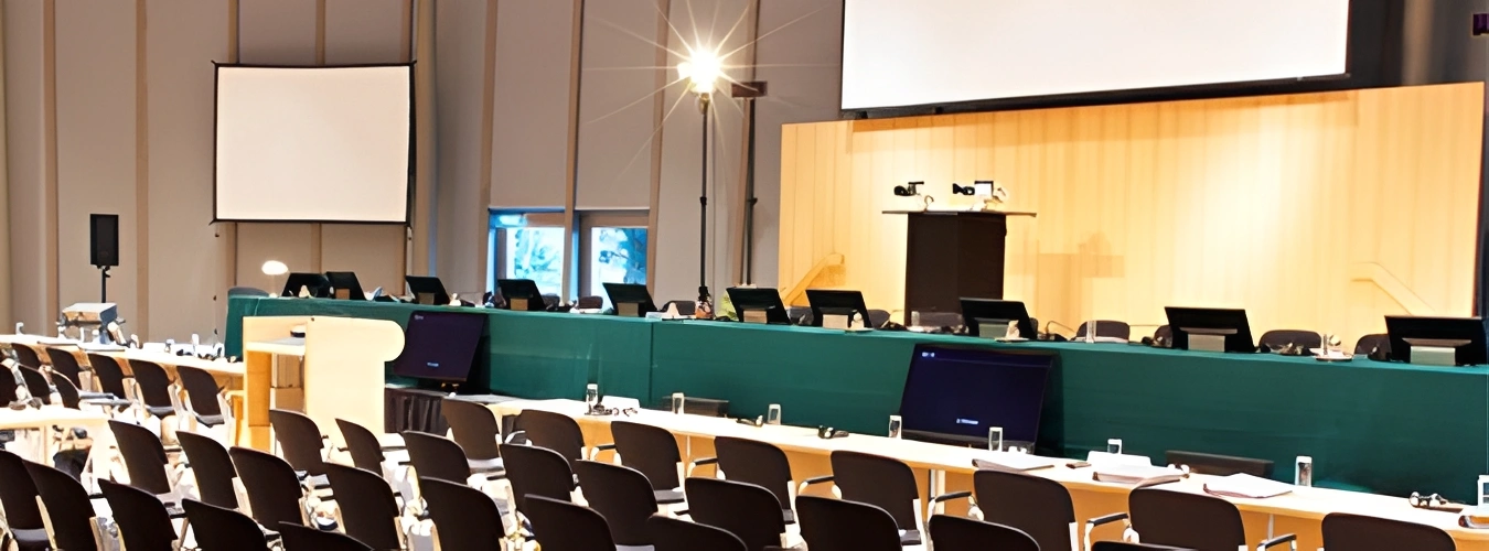 Large conference room with rows of chairs and tables arranged in neat rows